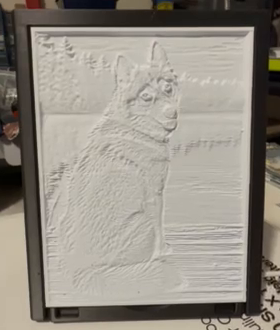 Actual dog portrait lithophane with the light switched off, showing the raised surface detail